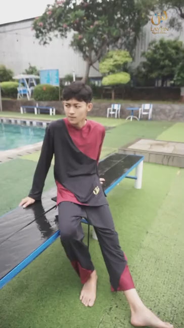 Close up details of black Layyin islamic mens swimwear with red trim worn by a Muslim man